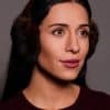 woman in brown earmuffs against a grey background