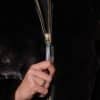 upclose shot of a female hand pulling down the zipper of a black mink jacket