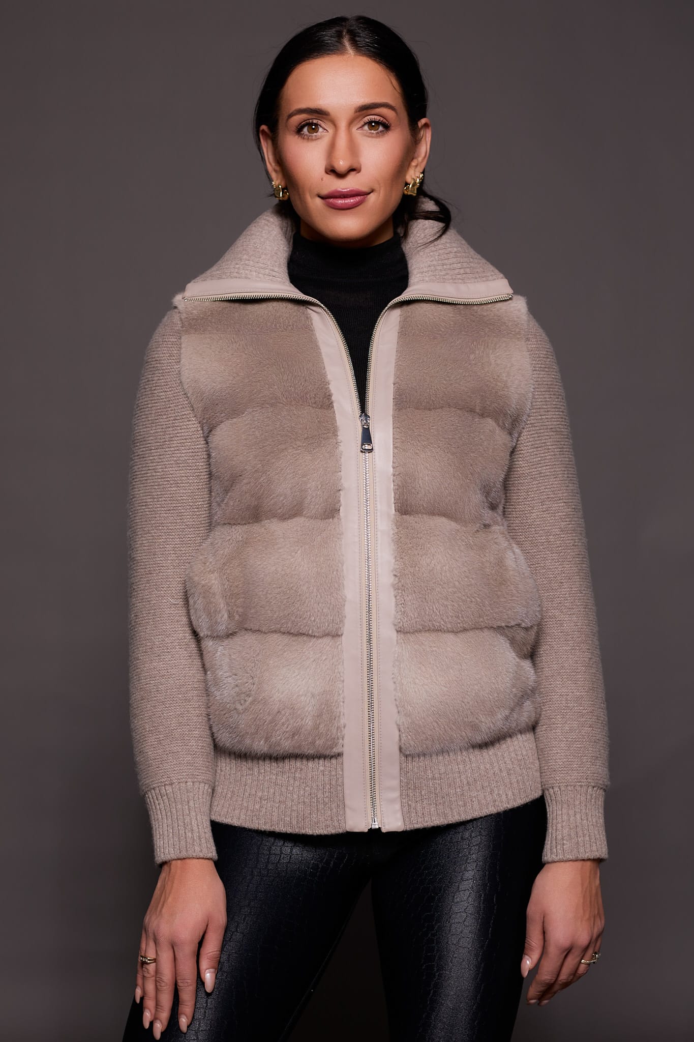 woman in a grey jacket against a grey background