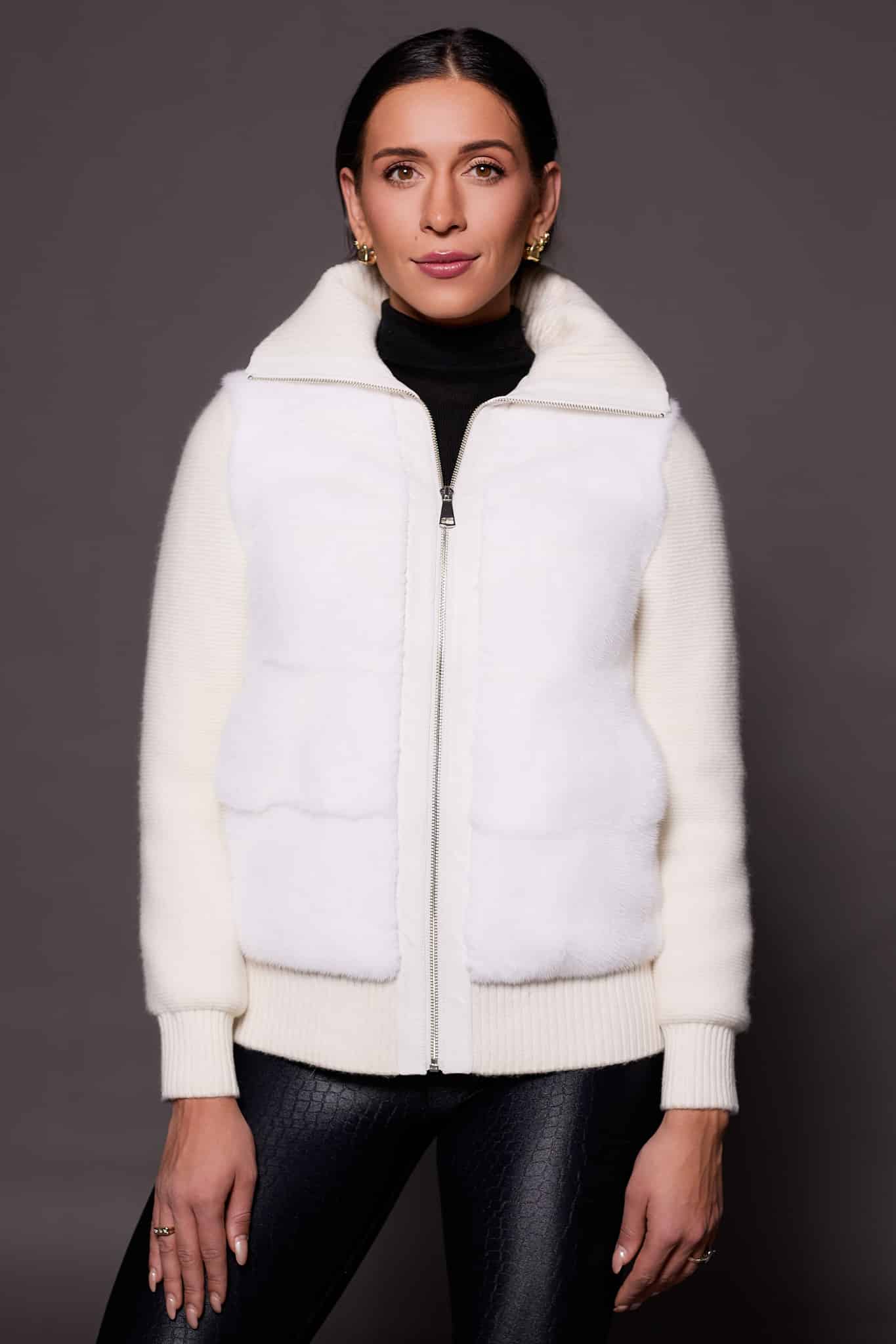 woman in a white jacket against a grey background