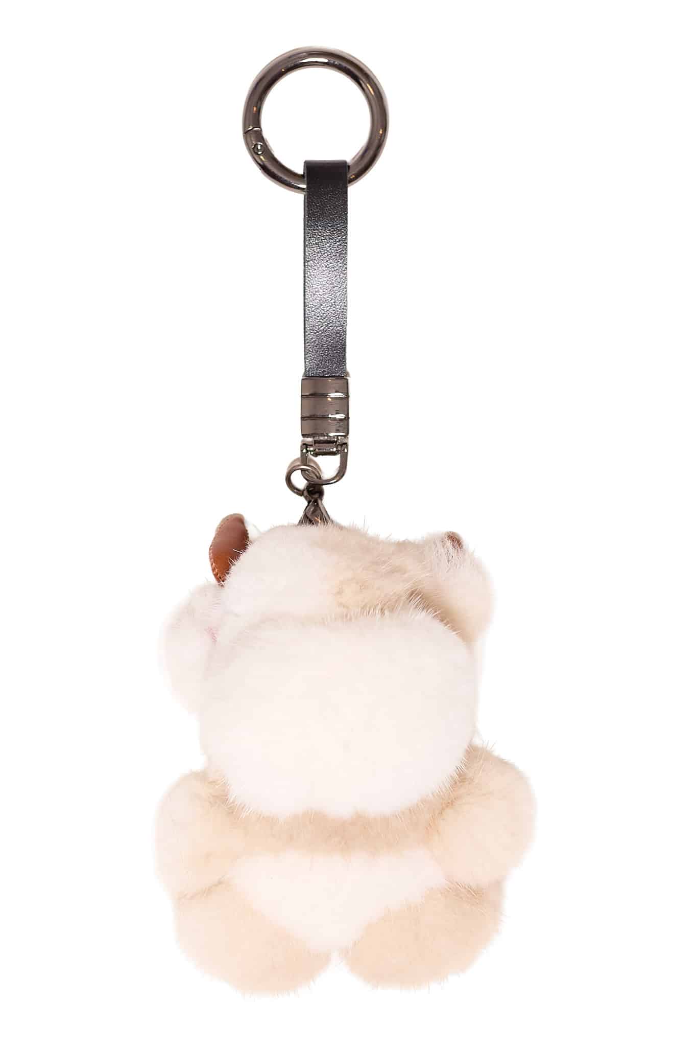 Mink Cow Key Chain Beige Beige colored mink cow keychain arranged atop a white background.