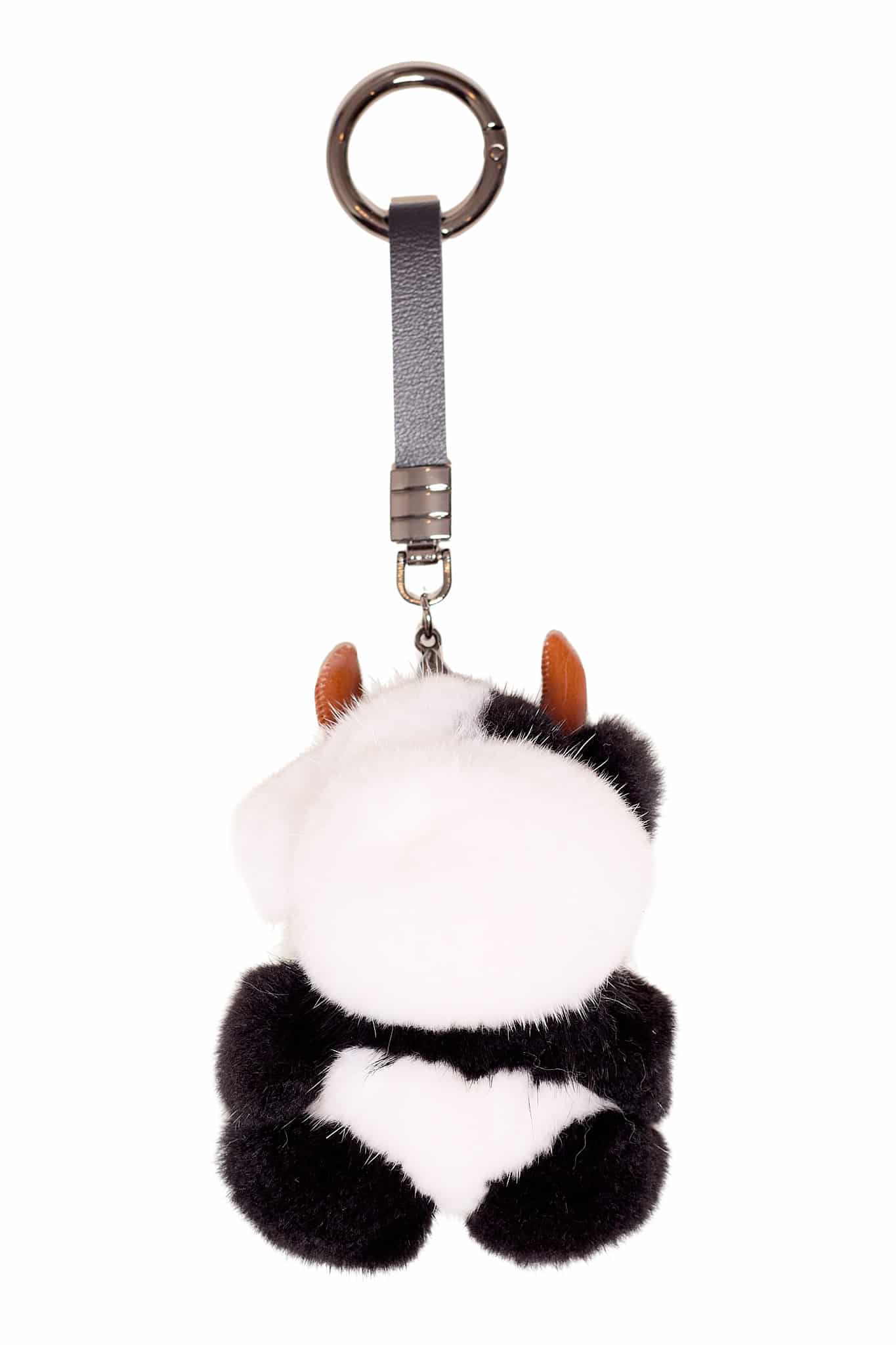 Black colored cow sheep keychain arranged atop a white background.