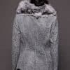 the back of a woman in a grey leather jacket with fur against a grey backdrop