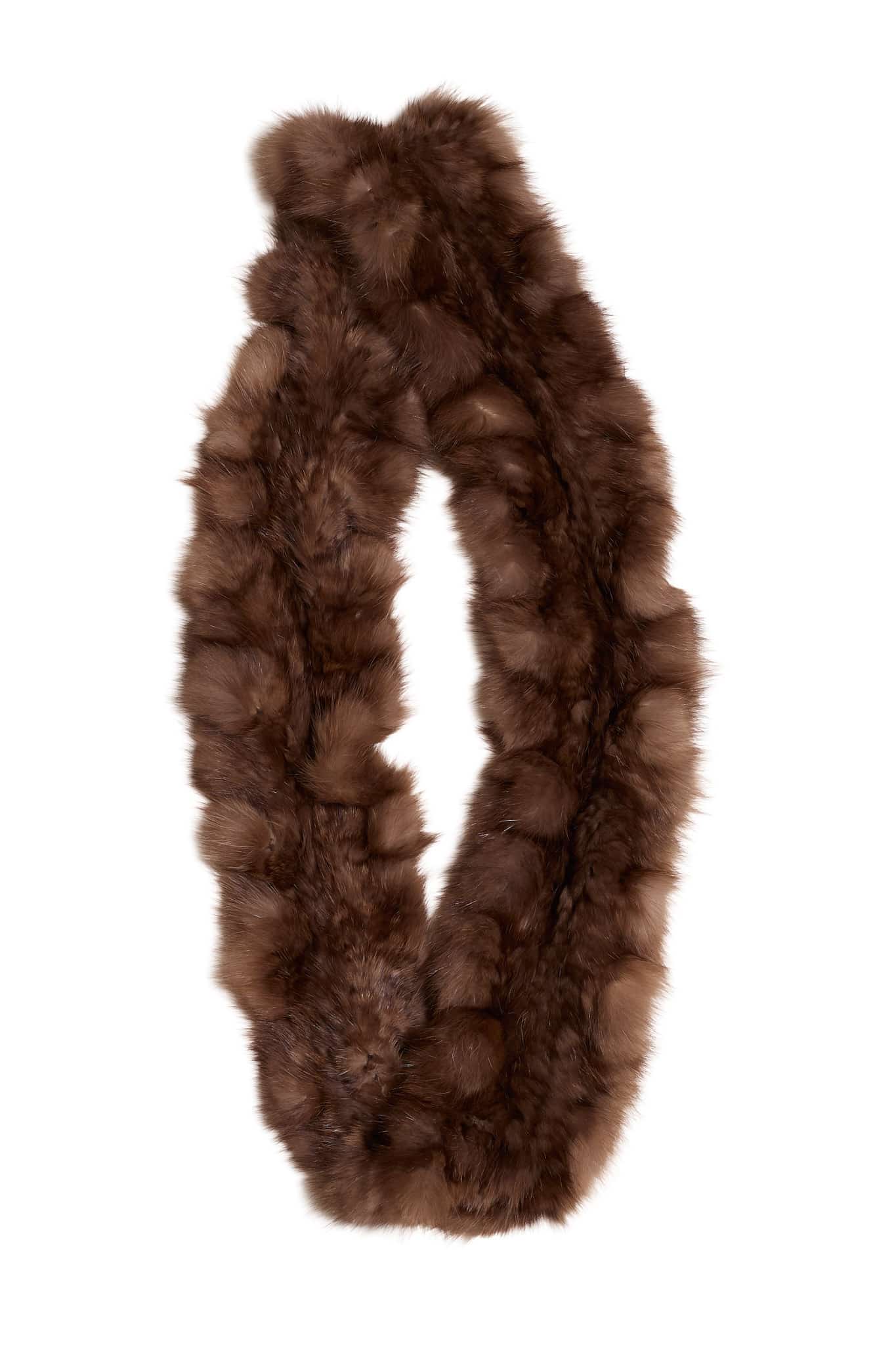 A sable fur infinity scarf folded on top of a white background.