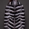 CARRIE CHINCHILLA NATURAL BACK the back of a woman in black and white fur coat against a grey background