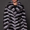 CARRIE CHINCHILLA NATURAL FRONT the front of a woman in black and white fur coat against a grey background