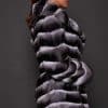 CARRIE CHINCHILLA NATURAL SIDE the side of a woman in black and white fur coat against a grey background