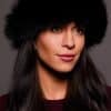 Frontal portrait shot of a woman wearing a black colored fox fur headband.
