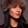 Frontal portrait shot of a woman wearing a crystal colored fox fur headband.