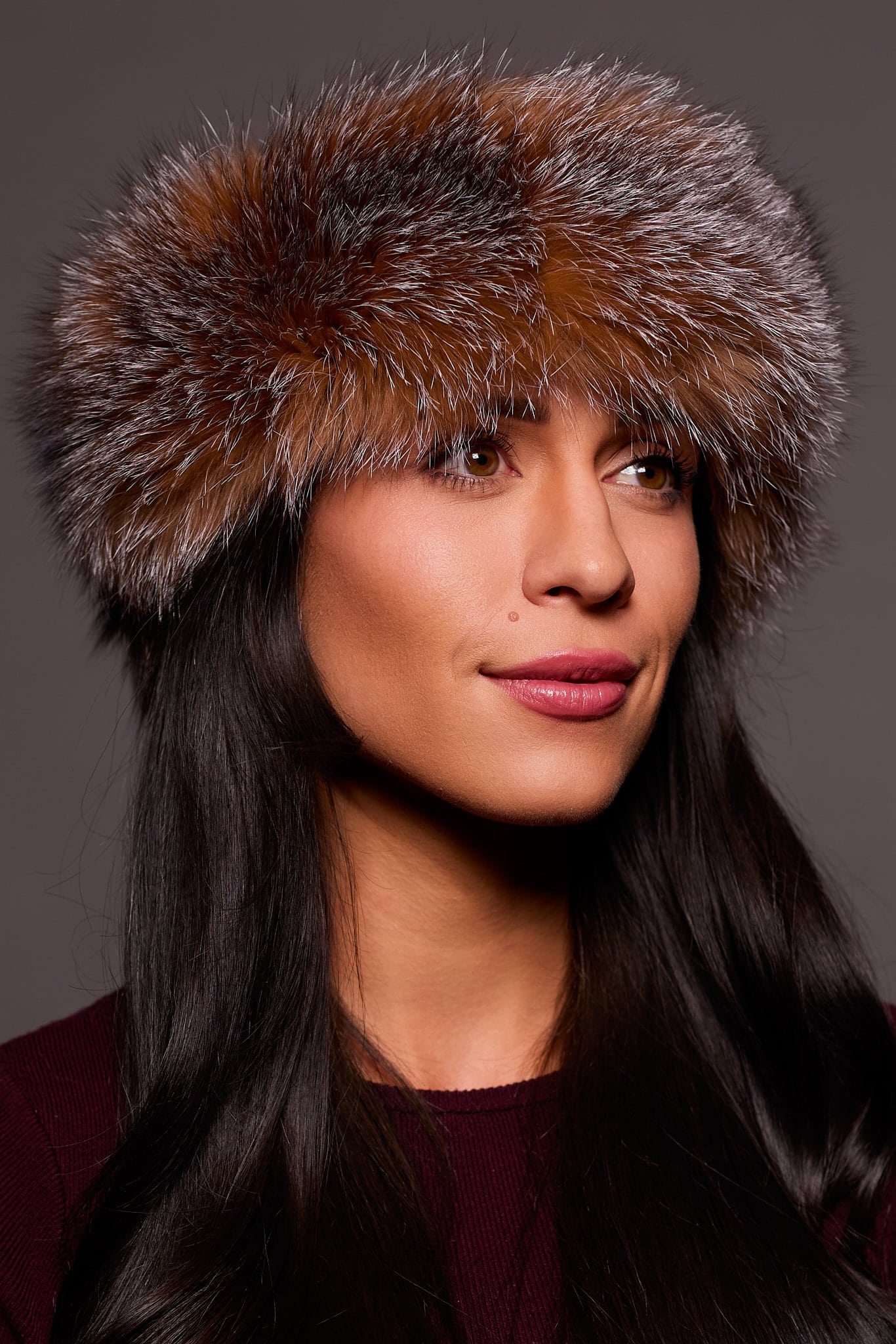 Frontal portrait shot of a woman wearing a crystal colored fox fur headband.
