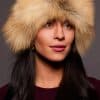 Frontal portrait shot of a woman wearing a golden isle colored fox fur headband.