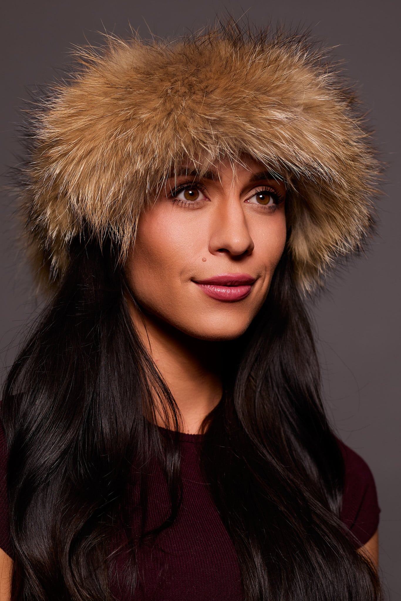 Frontal portrait shot of a woman wearing a tankuki colored fox fur headband.