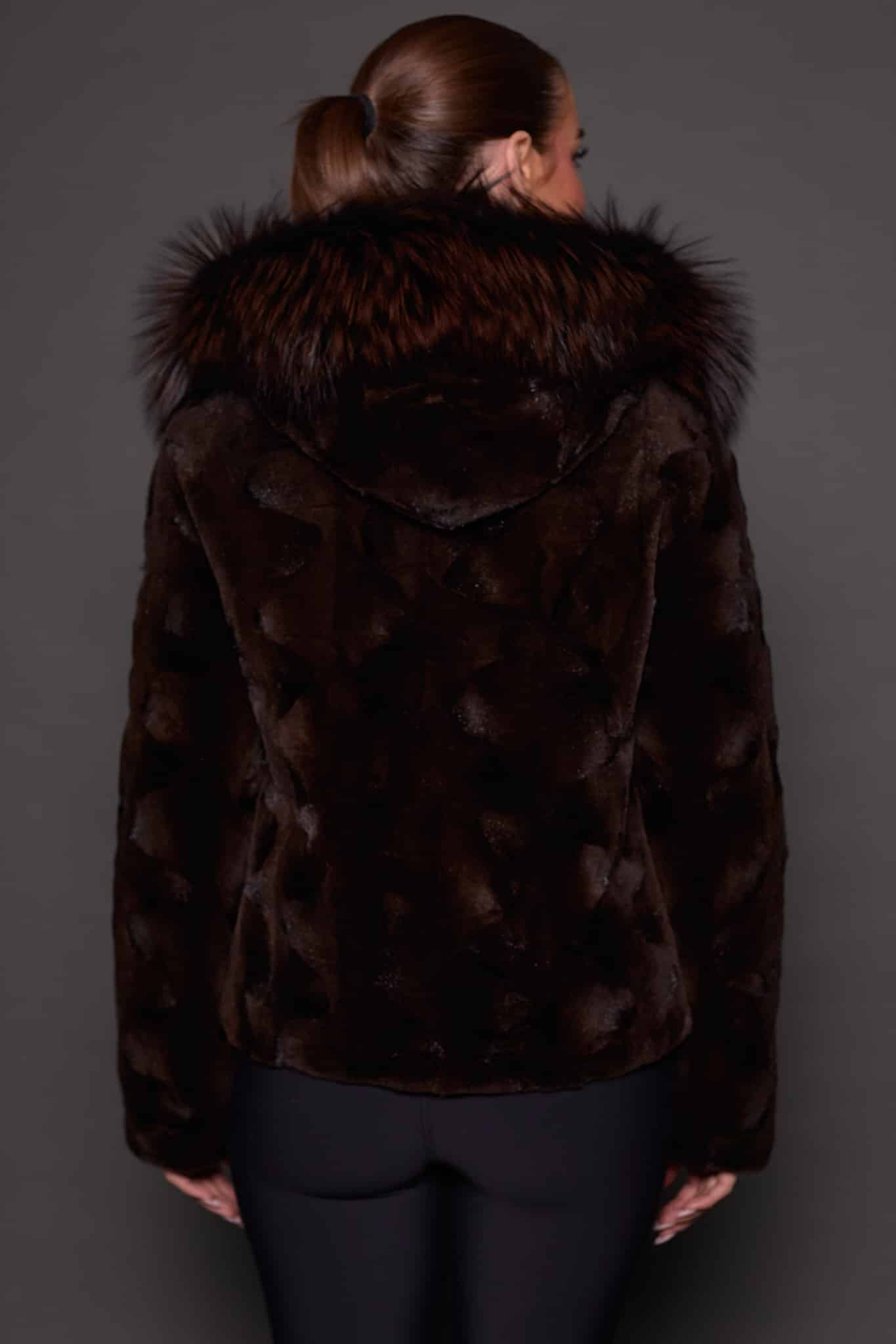 GIA MINK ESPRESSO SILVER FOX BACK the back of a woman in a brown fur jacket against a grey background