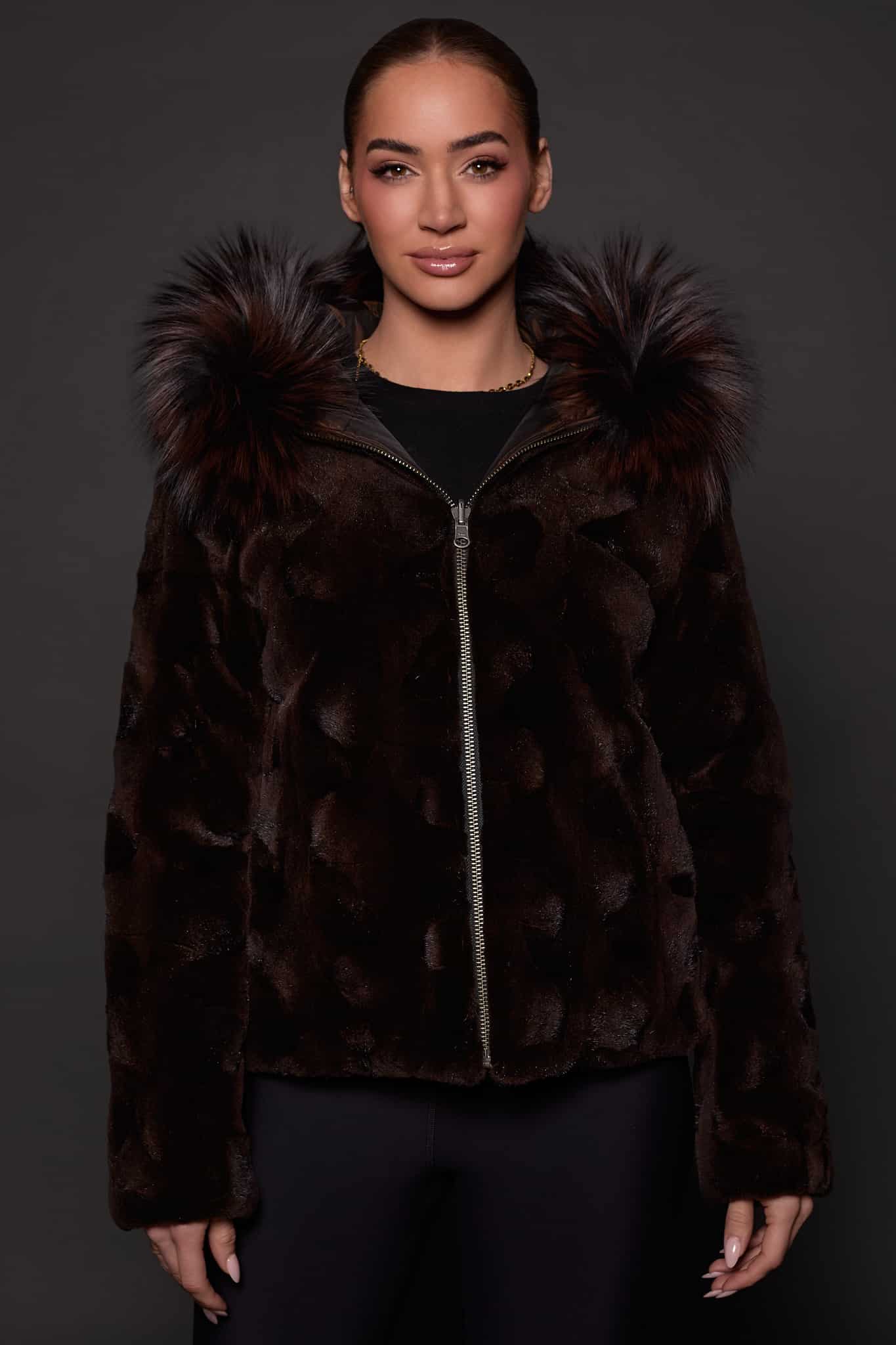 GIA MINK ESPRESSO SILVER FOX FRONT the front of a woman in a brown fur jacket against a grey background