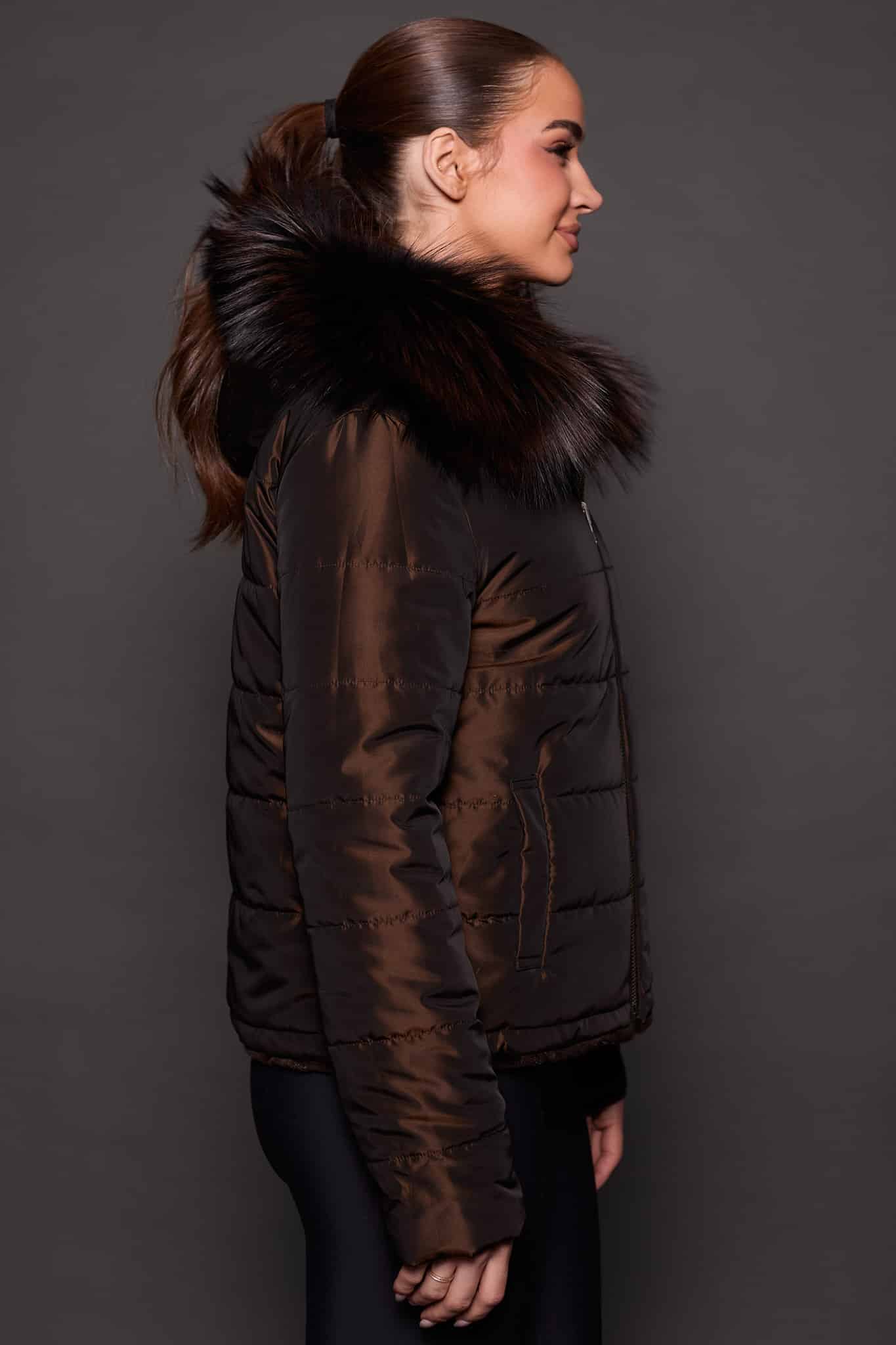 GIA MINK ESPRESSO SILVER FOX REVERSED SIDE the side of a woman in a brown fur jacket against a grey background