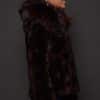 GIA MINK ESPRESSO SILVER FOX SIDE the side of a woman in a brown fur jacket against a grey background