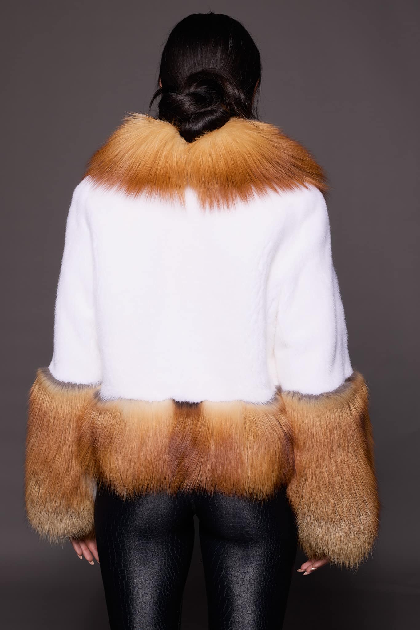 MARLEY MINK JACKET RED FOX BACK the back of a woman in a red and white fur jacket against a grey backdrop