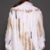 SASCHA REX KNIT WHITE BACK the back of a woman in a white fur knitted jacket against a grey background