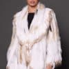SASCHA REX KNIT WHITE FRONT the front of a woman in a white fur knitted jacket against a grey background